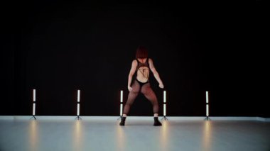 A dancer girl with a big ass in a thong dances erotically in hall. A captivating twerk, showcasing powerful movement and rhythm. Sexy woman dancing a seductive dance. Twerking, high heels, striptease.Energy and passion radiate from the performer's 