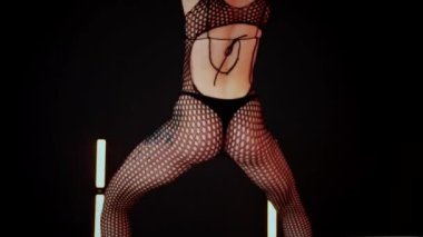 A dancer girl with a big ass in a thong dances erotically in hall. A captivating twerk, showcasing powerful movement and rhythm. Sexy woman dancing a seductive dance. Twerking, high heels, striptease.Energy and passion radiate from the performer's 