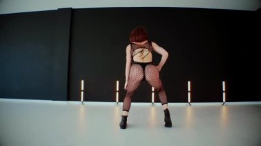 A dancer girl with a big ass in a thong dances erotically in hall. A captivating twerk, showcasing powerful movement and rhythm. Sexy woman dancing a seductive dance. Twerking, high heels, striptease.Energy and passion radiate from the performer's 