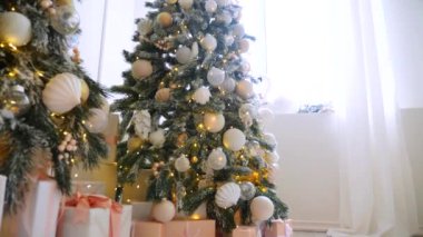 Narin süslemelerle süslenmiş şenlikli ağaçlar güzel bir sehpanın başında nöbet tutarlar. Zarif Noel süsleri. Hediyeler ve ağaçlar sıcak ve davetkar bir atmosfer yaratır. Bir Noel ziyafeti bekliyor. İkramlarla ve parıldayan ışıklarla dolu bir masa,