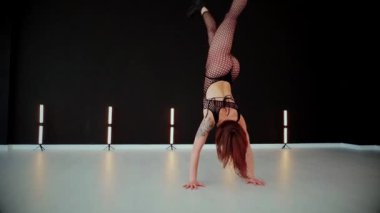 Büyük kalçalı, tangalı bir dansçı kız koridorda erotik bir şekilde dans ediyor. Büyüleyici bir twerk, güçlü bir hareket ve ritim sergiliyor. Baştan çıkarıcı dans eden seksi kadın. Kıvranma, yüksek topuklar, striptiz..