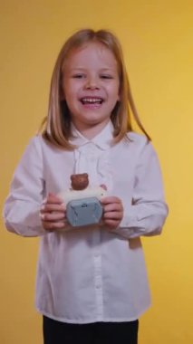 Dikey, pop-it oynayan küçük kız. Çocuk mutlu ve hevesle oyunu oynuyor. Kızın neşesi ve olumlu duyguları