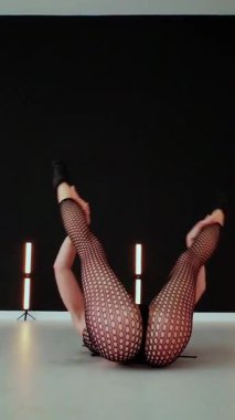 Dikey. Büyük kalçalı, tangalı bir dansçı kız koridorda erotik bir şekilde dans ediyor. Büyüleyici bir twerk, güçlü bir hareket ve ritim sergiliyor. Baştan çıkarıcı dans eden seksi kadın. Kıvranma, yüksek topuklar, striptiz..