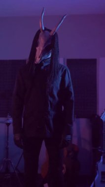 Dikey. Şeytan Canavarlar acı çeker, dans eder, sinirlenir. Karanlık Stüdyo 'da, korkunç maske takmış, kafatası şeklinde gizemli bir adam. Korku, Cadılar Bayramı, Cehennem