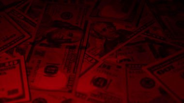 Canlı bir Amerikan para akışı var. Çok renkli ışıkta yıkanmış bir Amerikan doları yağmuru. ABD banknotlarının yakın plan görüntüsü. Detayları renkli bir renge bürünmüş. kağıt para döner.