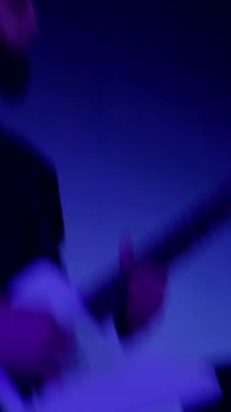 Dikey. Rock gitaristi bir rock konserinde havalı gitar çalar. Adam bir rock kulübünde elektro gitar çalıyor. Sakallı bir adam tutkulu bir şekilde elektro gitar çalar. Sakallı adam elektro gitarıyla ortalığı yıkıyor. Elektro gitar elinde.