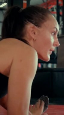 Dikey. Spor salonunda bir kadın, gücü ve hassasiyeti somutlaştırıyor. Ter parlıyor, kaslar çalışıyor. Bir bayan sporcu antrenman yapıyor, limitlerini zorluyor. Güçlü bir atletizm gösterisi. Güzel vücut şekilleri
