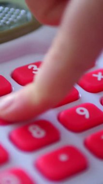 Dikey. Bir çocuğun elleri oyuncak kasasının renkli tuşlarına basıyor. Minyatür bir kasadaki düğmelere titizlikle basan bir çocuğun parmak görüntüsü. Çocuk yazar kasası.