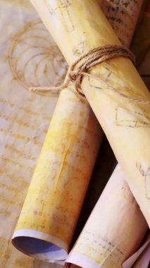 Dikey. Eski parşömen, zamana bağlı. Yıllanmış parşömenler ve mumlar. El yazmaları, antik belgeler, belgeler. Tarihi bir buluş, bir hazine. Kalem, çağların sırrı. Parşömenler, bir mum