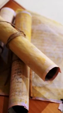 Dikey. Eski parşömen, zamana bağlı. Yıllanmış parşömenler ve mumlar. El yazmaları, antik belgeler, belgeler. Tarihi bir buluş, bir hazine. Kalem, çağların sırrı. Parşömenler, bir mum