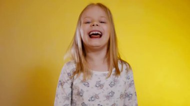 Desenli pijamalı genç kız iki tane turuncu mandalina tutuyor ve onlarla neşeyle oynuyor. Çocuk portakallarla gözlerini kapatıyor, neşeyle gülüyor ve sabah egzersizlerinde tuhaf hareket ediyor..