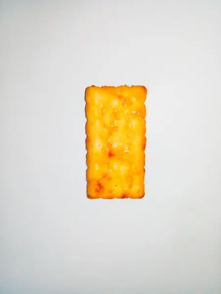 Square biscuit with liquid sugar on top. Biscuit are yellow.