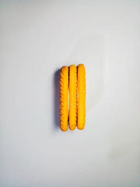 Three yellow stacked milk biscuits. Milk biscuits isolated on white background.