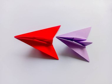 Kırmızı ve mor düzlem origamisi beyaz arkaplanda izole edildi.