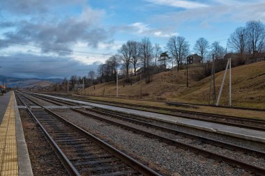 Railway rural station in the mountains. Desert platform of the station. Ukraine. Carpathians. Ivano-Frankivsk region. Yasinya station.