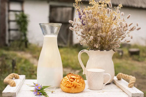 non-homogenized Homemade  milk on a vintage tray against the backdrop of a rustic yard
