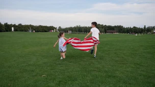 Mixed Race Boy Girl Playing American Flag Grassy Field 4Th Video Clip