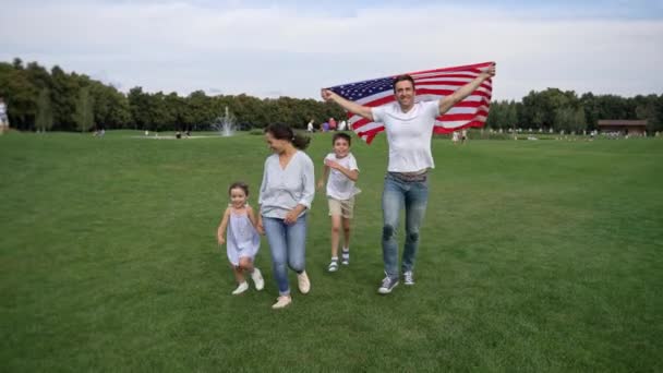 Beautiful Mixed Race Family Joyfully Running Park American Flag Blue Royalty Free Stock Video