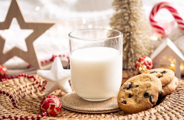 Çikolata parçalı kurabiyeler ve Noel Baba için bir bardak süt. Kış yeni yıl tatilini kutluyoruz..