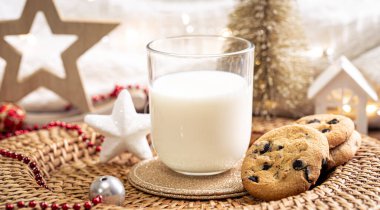 Çikolata parçalı kurabiyeler ve Noel Baba için bir bardak süt. Kış yeni yıl tatilini kutluyoruz..