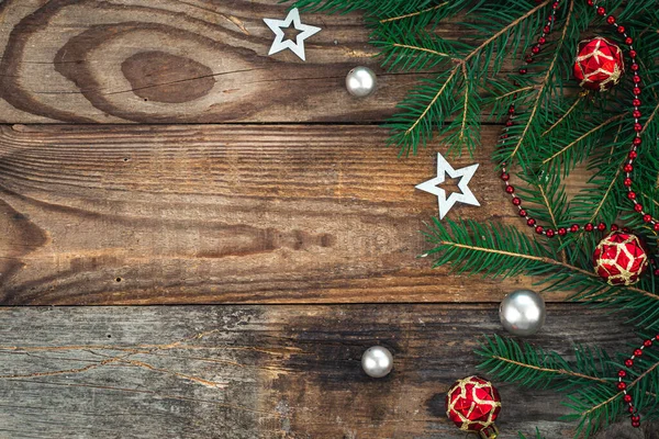 Stock image Wooden Christmas background with decor details and spruce branches, flat lay, copy space.