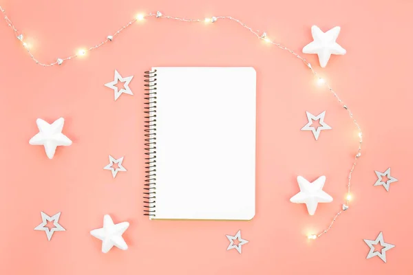 stock image Blank notebook with stars, garland are scattered next to the notebook. Place for a wish list, gifts or goals for the year.