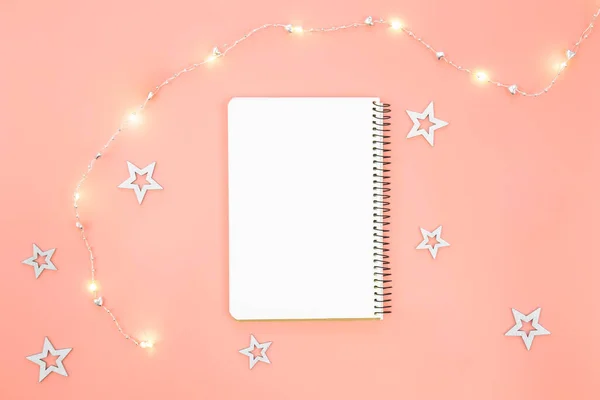 stock image Blank notebook with stars, garland are scattered next to the notebook. Place for a wish list, gifts or goals for the year.