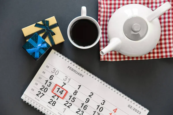 stock image Composition for Valentines Day with a calendar, gifts, a cup of tea and a teapot, top view.