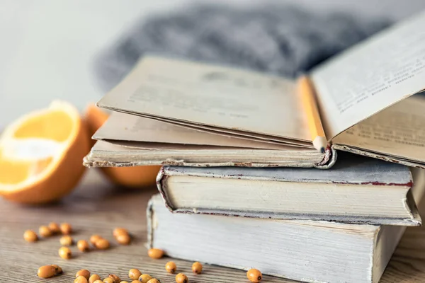 stock image Cozy home composition with a stack of books close-up on a blurred background.