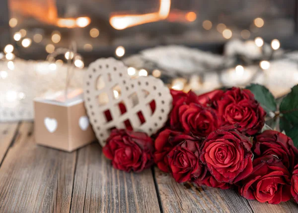 Festive background for Valentines Day with a bouquet of red roses and decor details, copy space.