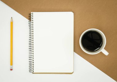 Blank notebook, coffee cup and pencil, flat lay, conceptual minimalism, copy space.