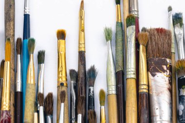 Close-up, old paint brushes on a white background, the concept of drawing and art.