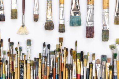 Many colored brushes for painting on a white background isolated, top view.