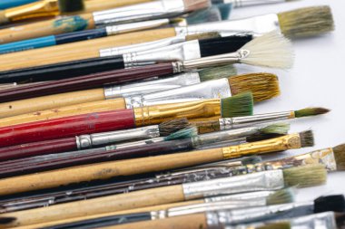 Close-up, old paint brushes on a white background, the concept of drawing and art.