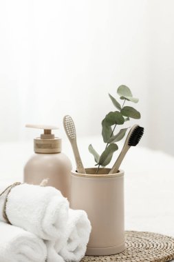 Spa composition with bamboo eco brushes on a white background and other personal hygiene items, copy space.
