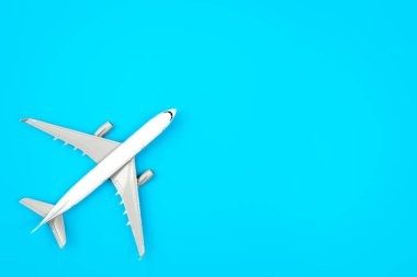 White plane, airplane on a blue background with copy space. Top view, flat lay. Minimal style design. Travel, vacation concept.