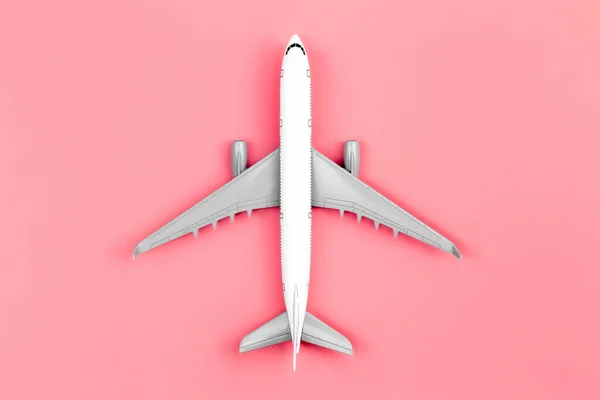 Airplane on a pink background, flat lay, travel concept, close up.