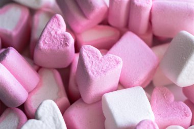 Pink and white marshmallows in the form of hearts, close-up, macro shot.
