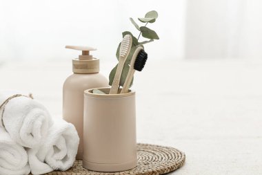 Spa composition with bamboo eco brushes on a white background and other personal hygiene items, copy space.