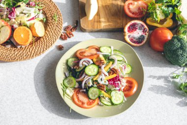 Fresh vegetable salad on the kitchen table in a plate close-up, the concept of healthy eating, weight loss and diet.