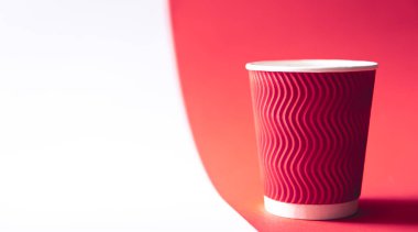 Disposable paper cup in trendy color Viva Magenta, copy space.
