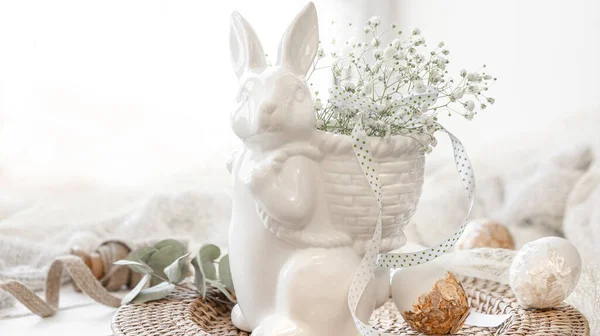 stock image Light Easter composition with a ceramic hare, eggs and gypsophila flowers.