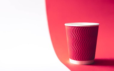 Disposable paper cup in trendy color Viva Magenta, copy space.