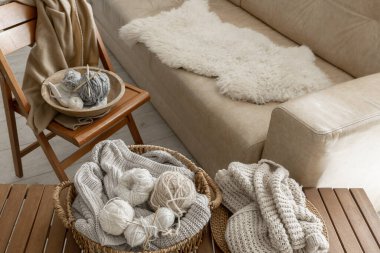 Threads for knitting in the interior of the room, a cozy composition with yarn, Scandinavian style. clipart