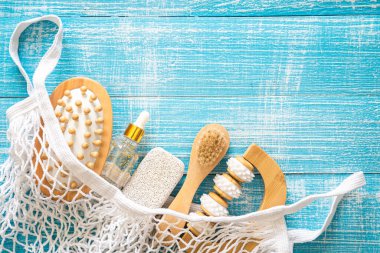 Vücut bakımı için kişisel hijyen malzemelerini içeren spa kompozisyonu mavi ahşap bir arka planda, üst görünümde, kopyalama alanı.