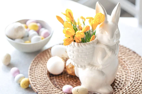 stock image Easter still life with ceramic hare, decorative eggs and first spring flowers.