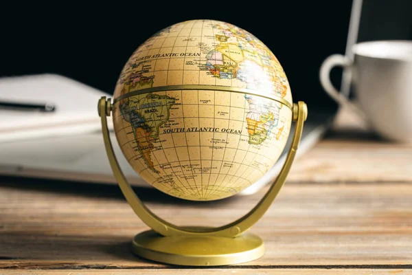 Close up, Earth globe on wooden surface, travel, tourism and geography concept.