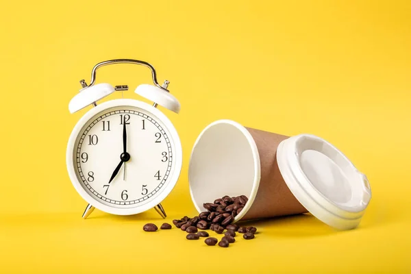 Relógio Despertador Xícara Papel Grãos Café Fundo Amarelo Isolado Conceito — Fotografia de Stock