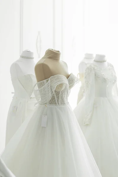 Boutique wedding dress on mannequin in bridal store, fashion concept.