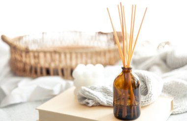 Bulanık arkaplanda tütsü çubukları ve örgü ögesi olan spa kompozisyonu, boşluğu kopyala.